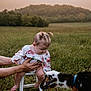 baby, child, goat, animal, grass, field, stool, hand, nature, outdoor, pigtails, curious, foot, person, animal_interaction, green, sunset, support, cute, portrait