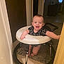 baby, carpet, child, clothing, cute, doorway, face, floor, hand, happy, head, home, indoor, infant, legs, person, smiling, standing, toy, walker