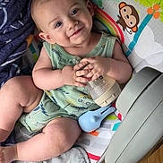 Rowdie joined the competition — help win amazing prizes! baby, blanket, blue_eyes, bottle, child, clothing, cute, elephant, floor, green, hand, happy, indoors, infant, legs, monkey, rainbow, seat, smile, toy