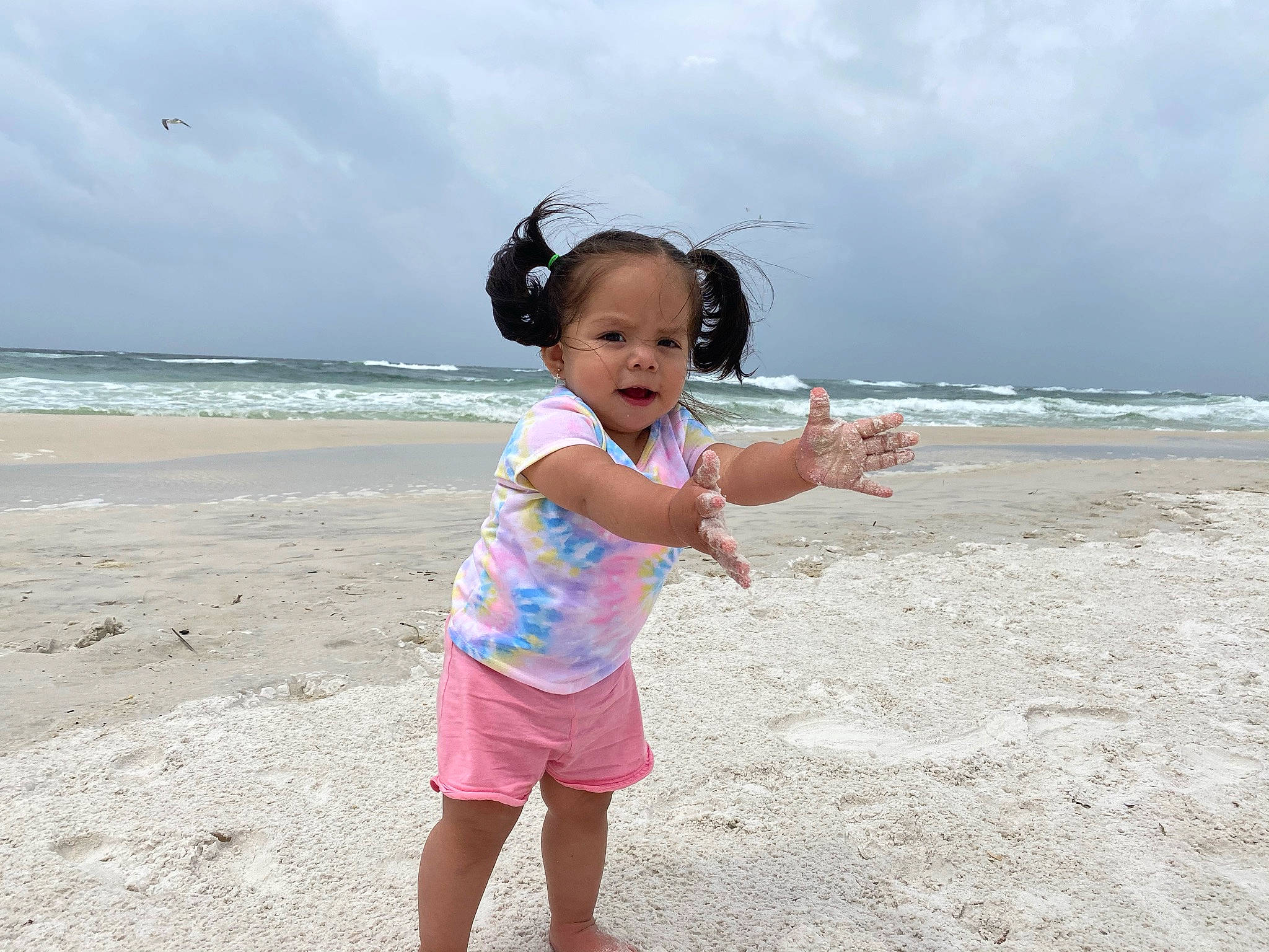 Zelah is registered to the contest to win money with this photo: baby_toddler_clothing, beach, cloud, eye, flash_photography, fun, happy, hat, leisure, natural_environment, people_in_nature, people_on_beach, person, sand, sky, summer, t_shirt, toddler, travel, water