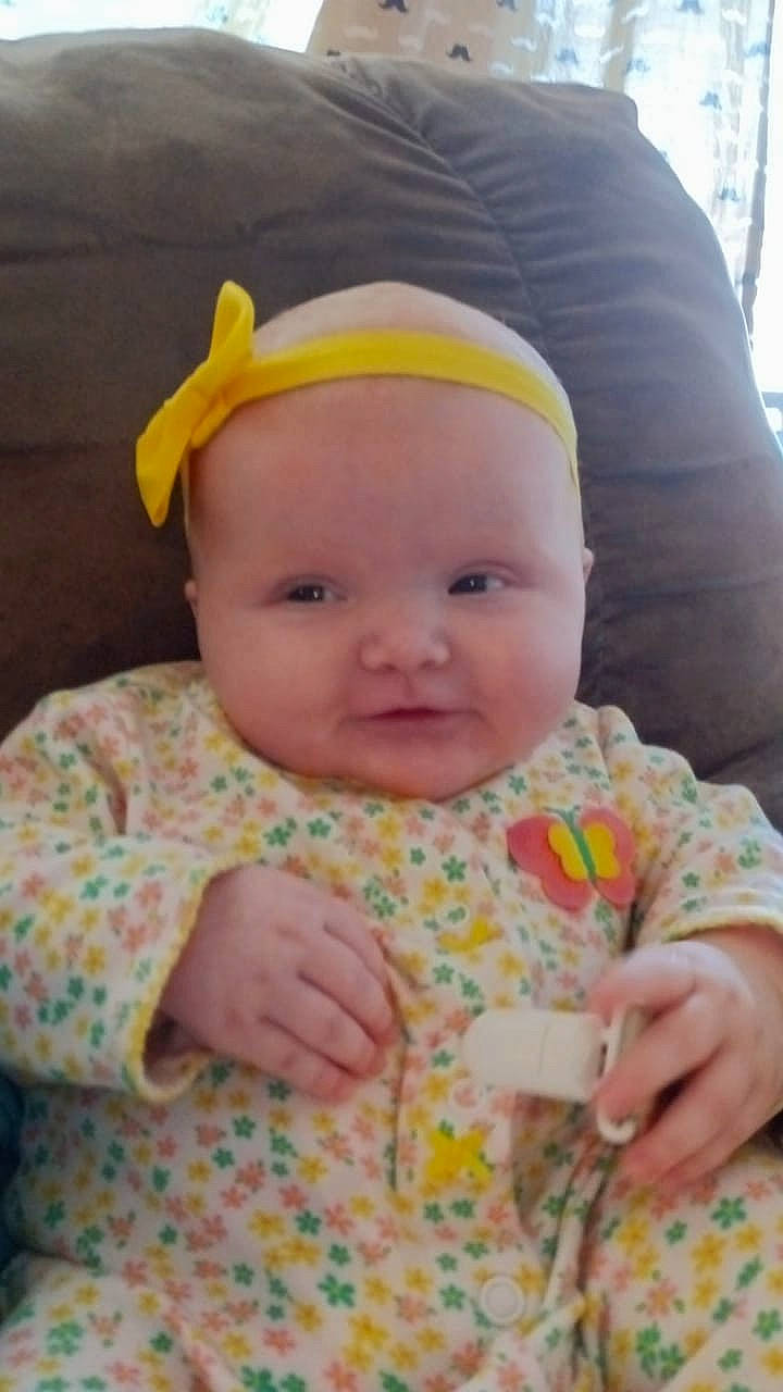 Cara is registered to the contest to win money with this photo: baby, baby_toddler_clothing, cheek, child, comfort, eye, eyebrow, fun, happy, iris, lip, nose, pattern, person, pink, sitting, skin, sleeve, smile, textile