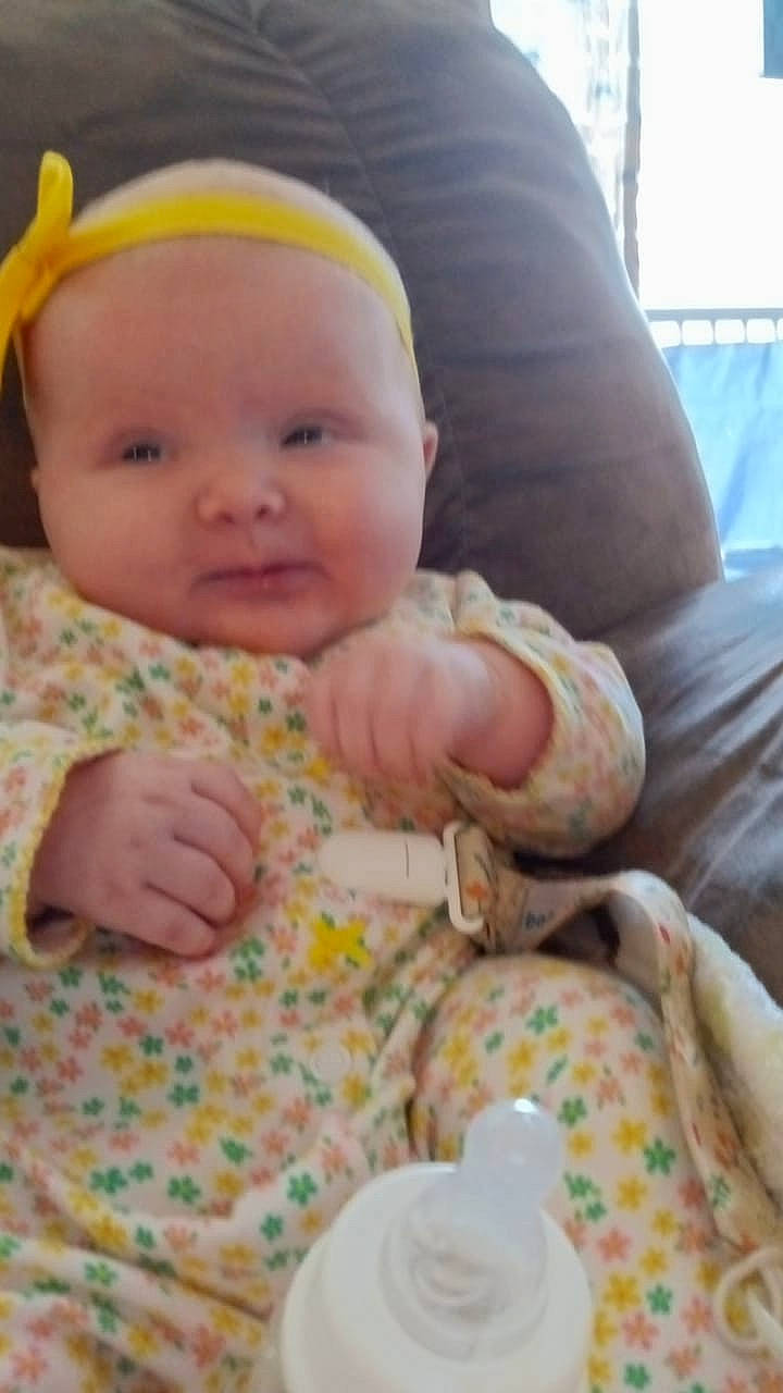 Cara is registered to the contest to win money with this photo: baby, baby_toddler_clothing, cheek, child, comfort, grass, happy, hat, head, lap, linens, person, sitting, skin, sleeve, smile, textile, thumb, toddler