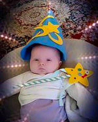 Cara is registered to the contest to win money with this photo: baby, baby_products, baby_toddler_clothing, cap, child, cloud, cool, costume_hat, event, finger, fun, happy, hat, headgear, human_body, party_hat, party_supply, person, photo_caption, sky