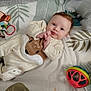 Lisa participe au concours pour gagner de l'argent avec cette photo : baby, infant, onesie, deer_design, toy, blanket, leaf_pattern, face, smile, curious, lying_down, indoor, cute, child, playtime, soft_toys, colorful, young, person, cozy