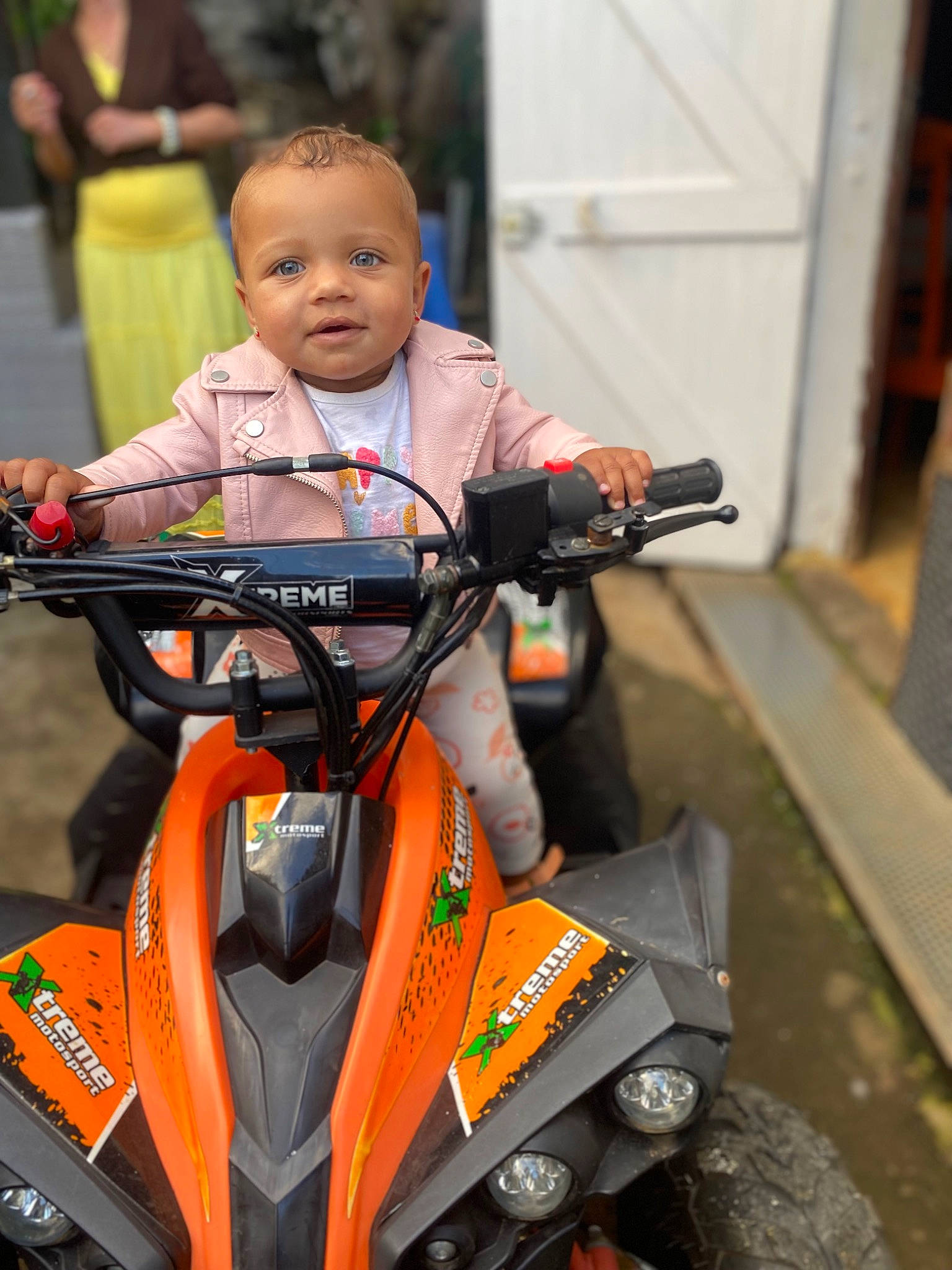 Lovaïnna a rejoint le concours — aidez-le/la à gagner de superbes lots ! auto_part, automotive_design, automotive_exterior, automotive_lighting, automotive_tire, fender, head, headlamp, motor_vehicle, motorcycle, motorcycle_accessories, motorcycling, motorsport, orange, person, personal_protective_equipment, rim, tire, toddler, vehicle