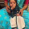 baby, bindi, blue, bracelet, child, cultural, cute, foot, gold, hand, holding, indoor, infant, jewelry, lap, person, portrait, ring, saree, traditional_clothing