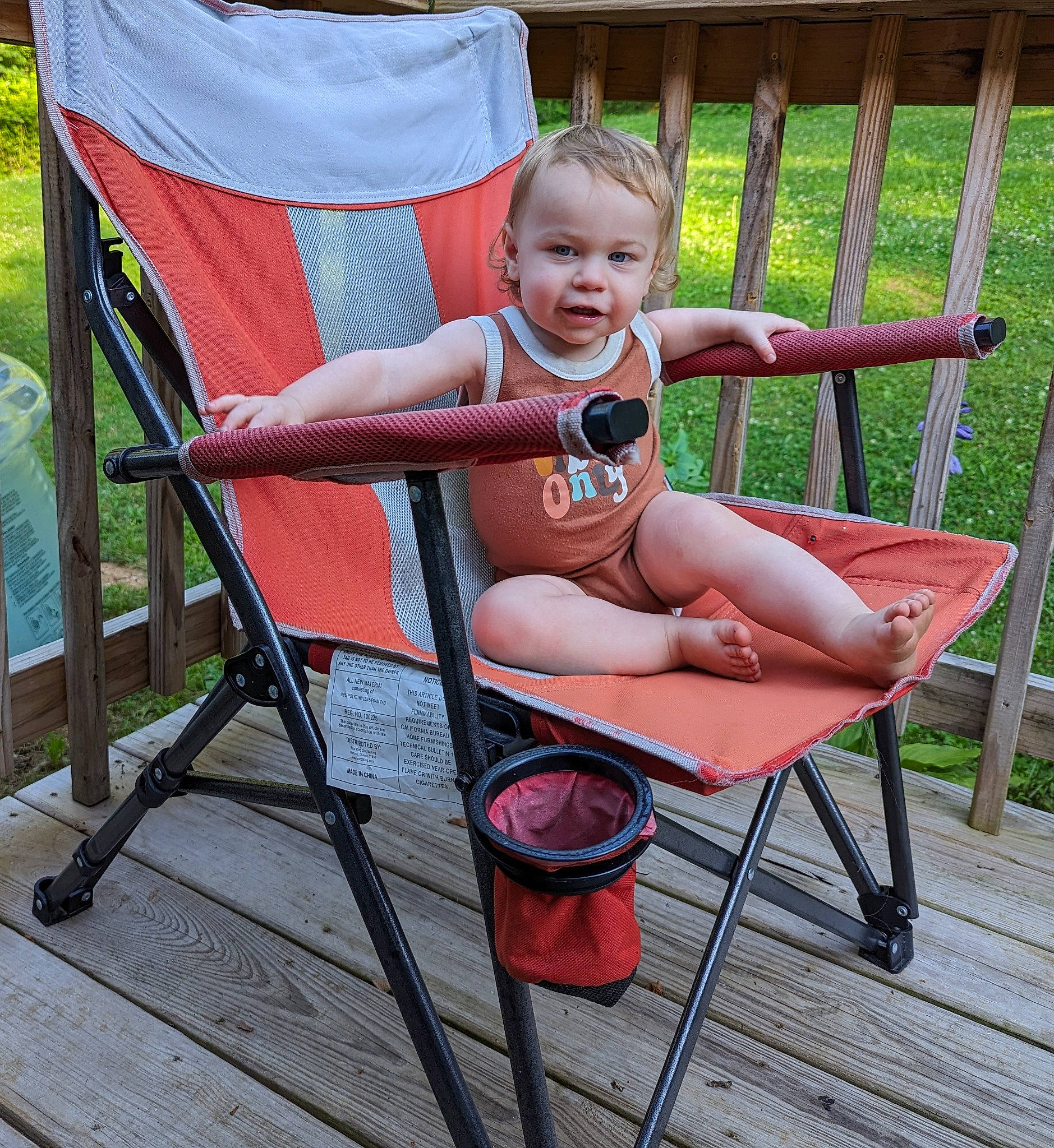 Atticus joined the competition — help win amazing prizes! armrest, baby, baby_products, baby_toddler_clothing, chair, comfort, folding_chair, foot, furniture, grass, human_leg, lap, leg, leisure, outdoor_furniture, person, shorts, sitting, smile, thigh
