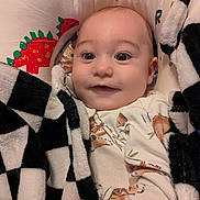 Oliver is registered to the contest to win money with this photo: baby, blanket, checkered, child, clothing, cozy, cute, cute_expression, dinosaur, face, happy, indoor, infant, pattern, pillow, portrait, smile, soft, wrapped, young