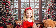 Aria Robinson joined the competition — help win amazing prizes! bow, celebration, child, christmas_tree, decoration, festive, gift_box, girl, happy, headband, holiday, indoors, ornament, plush_toy, red_dress, smile, snow, teddy_bear, window, winter