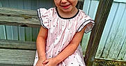 Charlena St. Angelo joined the competition — help win amazing prizes! bow, casual, child, cute, dress, footwear, girl, hair, happy, nature, outdoor, person, playful, polka_dot, portrait, sandals, sitting, smile, wooden_steps, young
