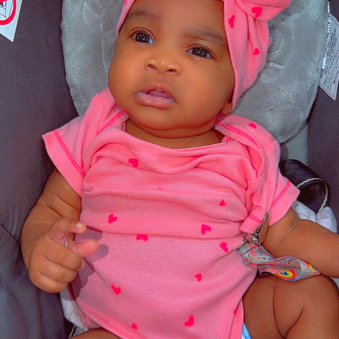 Royalty joined the competition — help win amazing prizes! baby, infant, child, portrait, car_seat, pink_outfit, bow, headband, hearts, sitting, face, eyes, indoors, close_up, fashion, socks, blanket, harness, cute, photography