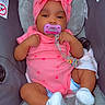 Royalty joined the competition — help win amazing prizes! baby, infant, child, car_seat, pink_outfit, headband, bow, pacifier, smiling, portrait, sitting, indoors, vehicle, heart_pattern, socks, diaper, toy_clip, cushion, photography, happy