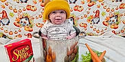 Elvis joined the competition — help win amazing prizes! baby, child, cooking_pot, vegetables, carrots, potatoes, celery, pumpkins, stove_top_box, hat, yellow_hat, fall_theme, autumn, gnomes, leaves, background, smiling, cute, indoors, festive