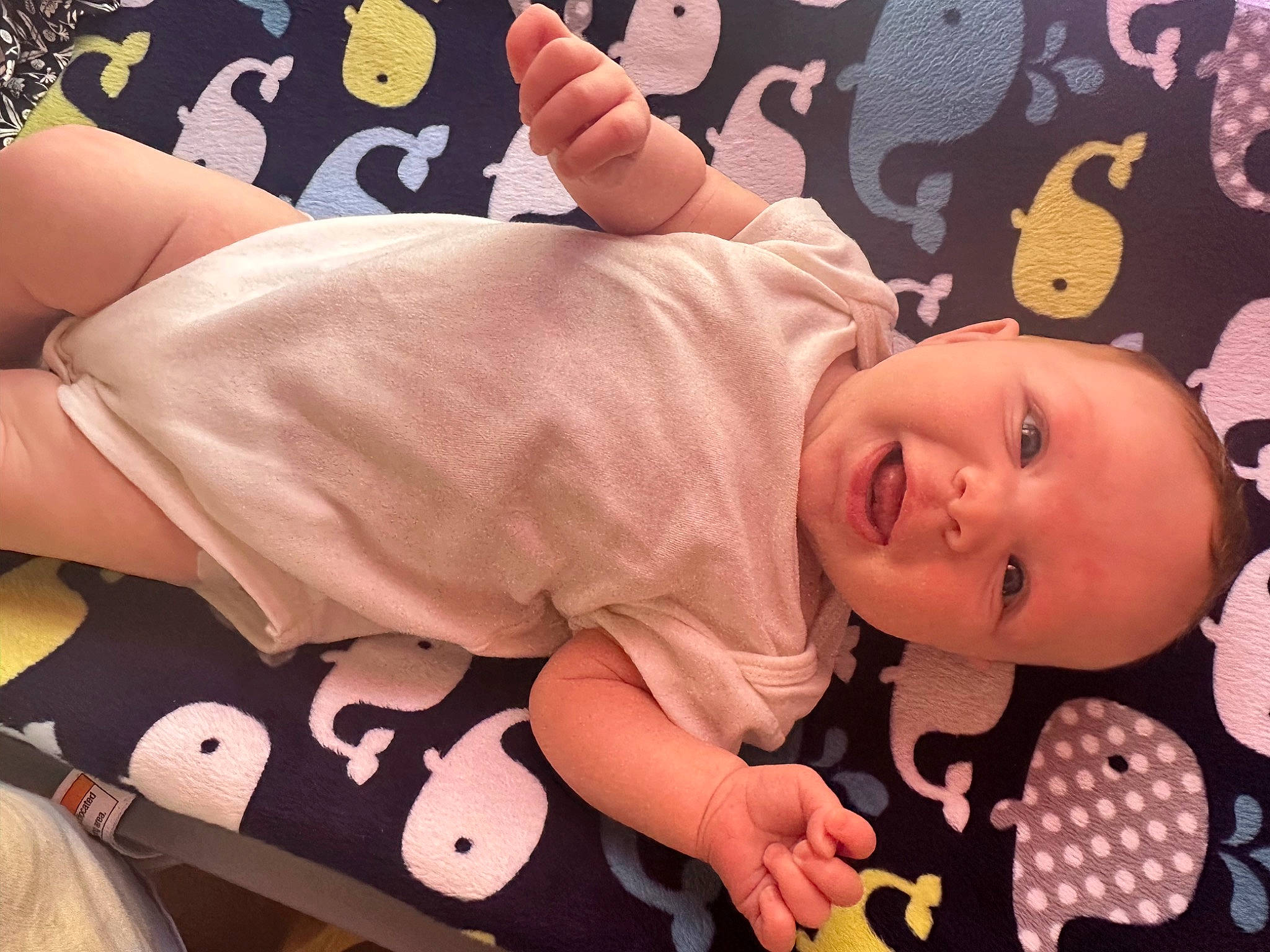 Carley is registered to the contest to win money with this photo: baby, baby_products, baby_sleeping, baby_toddler_clothing, bed, cheek, child, comfort, happy, head, human_leg, linens, orange, pattern, person, pink, room, skin, sleeve, toddler