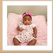Elizabeth joined the competition — help win amazing prizes! baby, infant, pink_headband, heart_pattern, pink_blanket, cute, child, portrait, sitting, soft_texture, clothing, indoor, young_child, adorable, face, expression, headwear, relaxing, cozy, photography