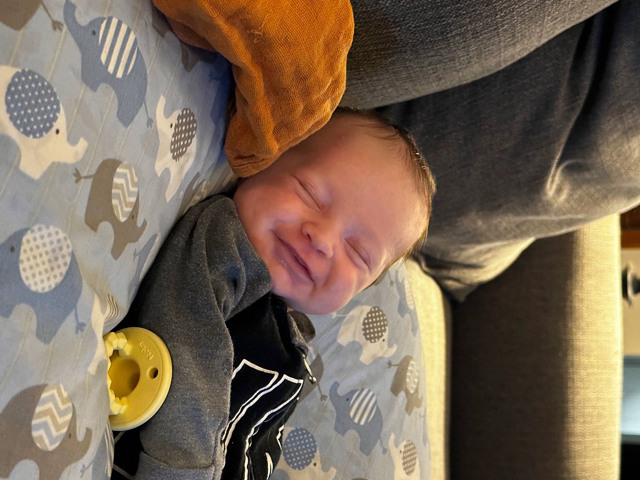 Lennox joined the competition — help win amazing prizes! baby, baby_toddler_clothing, child, comfort, flooring, happy, joy, linens, nap, pattern, person, portrait_photography, room, sitting, sleep, sleeve, smile, textile, toddler, wood