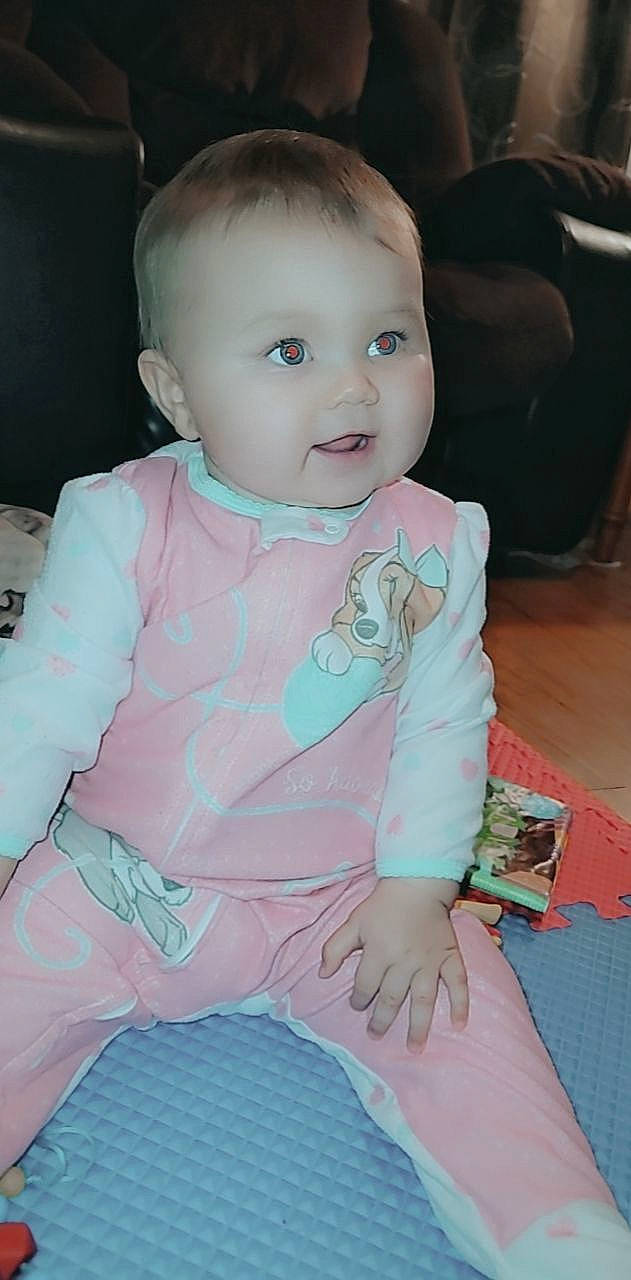 Davina is registered to the contest to win money with this photo: baby, baby_toddler_clothing, cheek, child, chin, comfort, eye, face, finger, hair, hairstyle, head, human_body, iris, lap, neck, person, pink, skin, sleeve