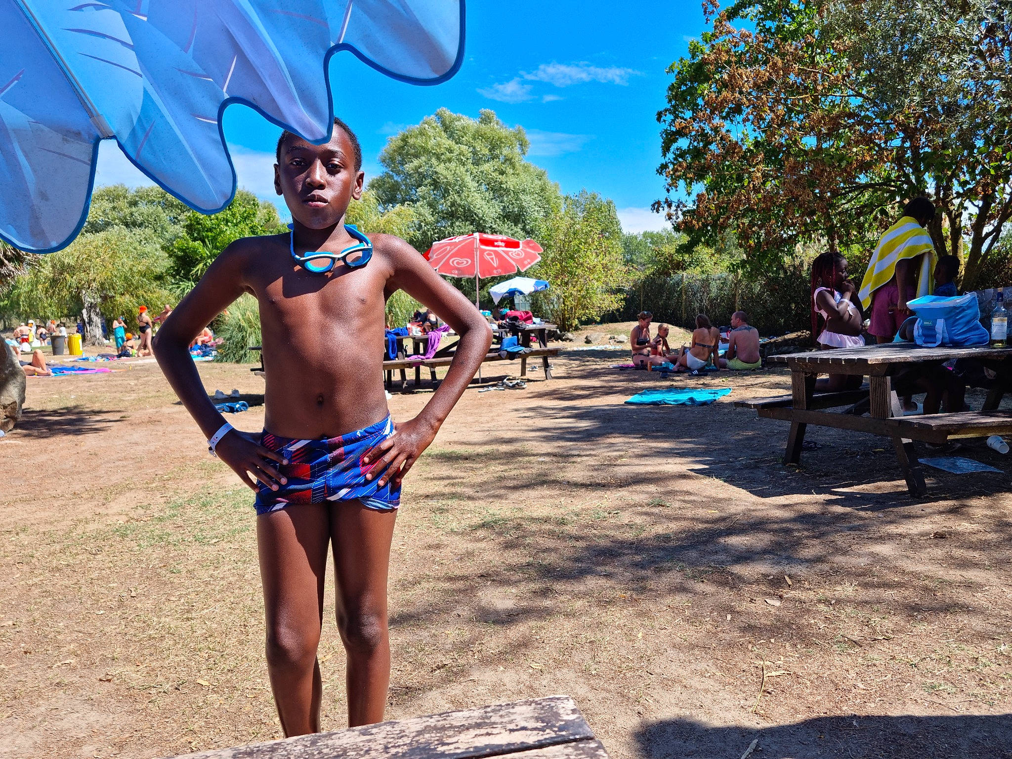 Pharell participe au concours pour gagner de l'argent avec cette photo : abdomen, barechested, brassiere, chest, electric_blue, event, eyewear, fun, leisure, navel, people_on_beach, person, recreation, sky, swimsuit_top, swimwear, thigh, tree, trunk, undergarment