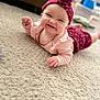 Aphelia Kay joined the competition — help win amazing prizes! baby, smiling, headband, flower, carpet, indoor, child, cute, pink_clothing, happy, portrait, toddler, face, person, soft_texture, floor, infant, lying_down, home, playful