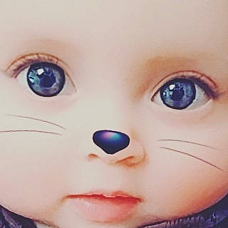 Ninon participe au concours pour gagner de l'argent avec cette photo : cheek, child, close_up, doll, eye, eyebrow, eyelash, face, forehead, head, iris, lip, mouth, nose, organ, person, skin, smile, toy, violet