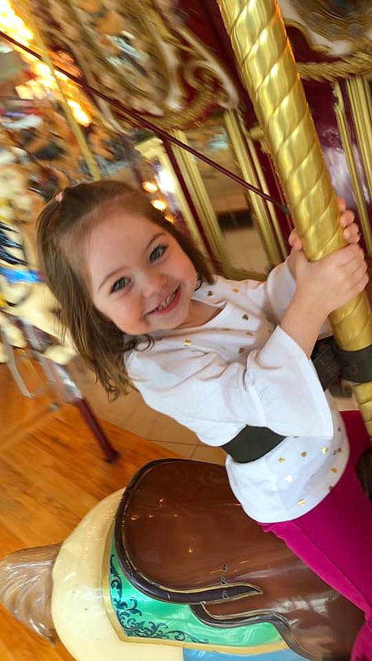Avalyn is registered to the contest to win money with this photo: amusement_park, amusement_ride, blond, carousel, child, fun, girl, happiness, human_hair_color, joy, leisure, park, person, recreation, smile, toddler