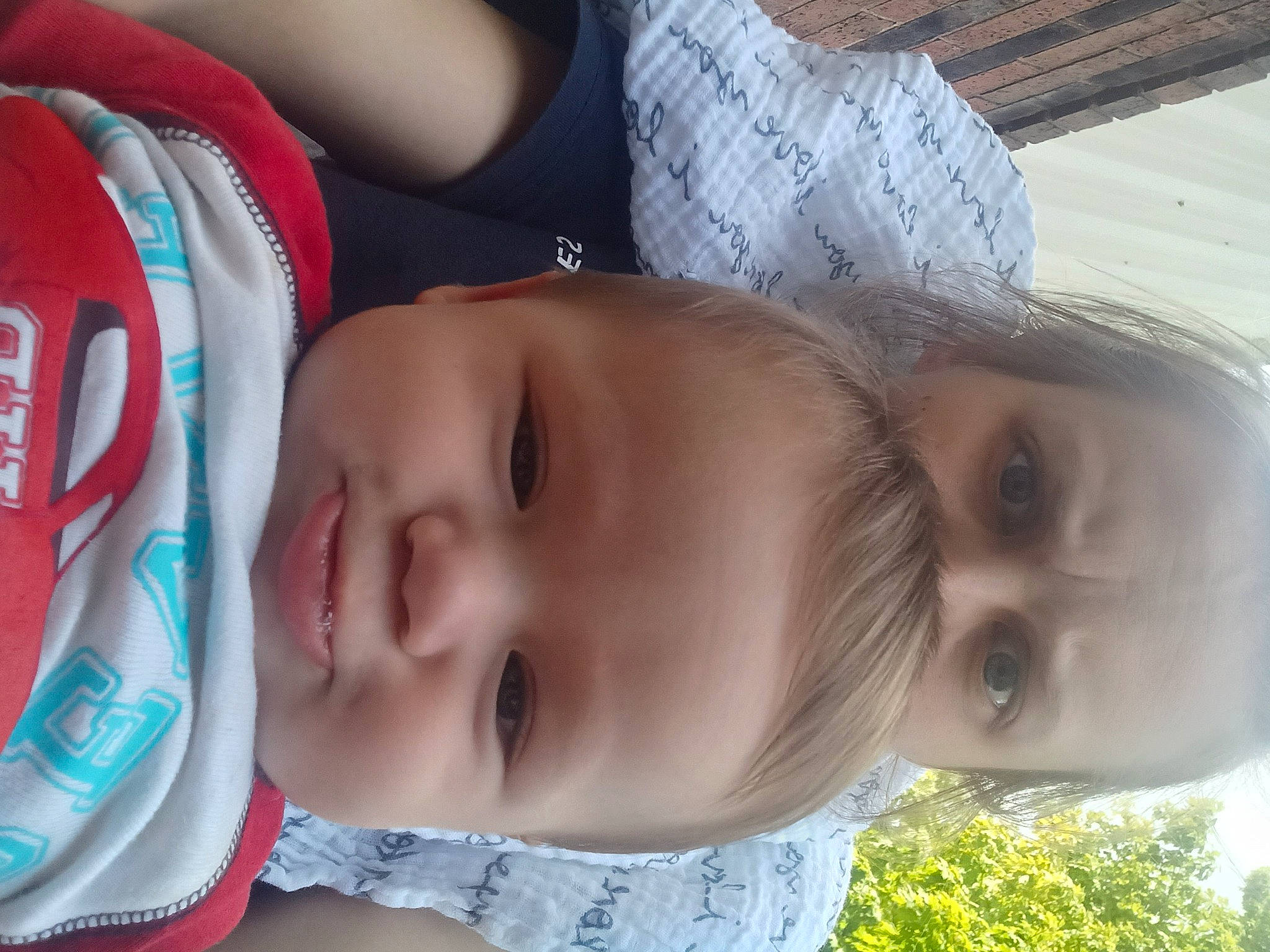 Loyal is registered to the contest to win money with this photo: baby, baby_toddler_clothing, cheek, child, chin, eyebrow, eyelash, facial_expression, forehead, happy, head, headgear, iris, lip, mouth, nose, person, plant, skin, smile