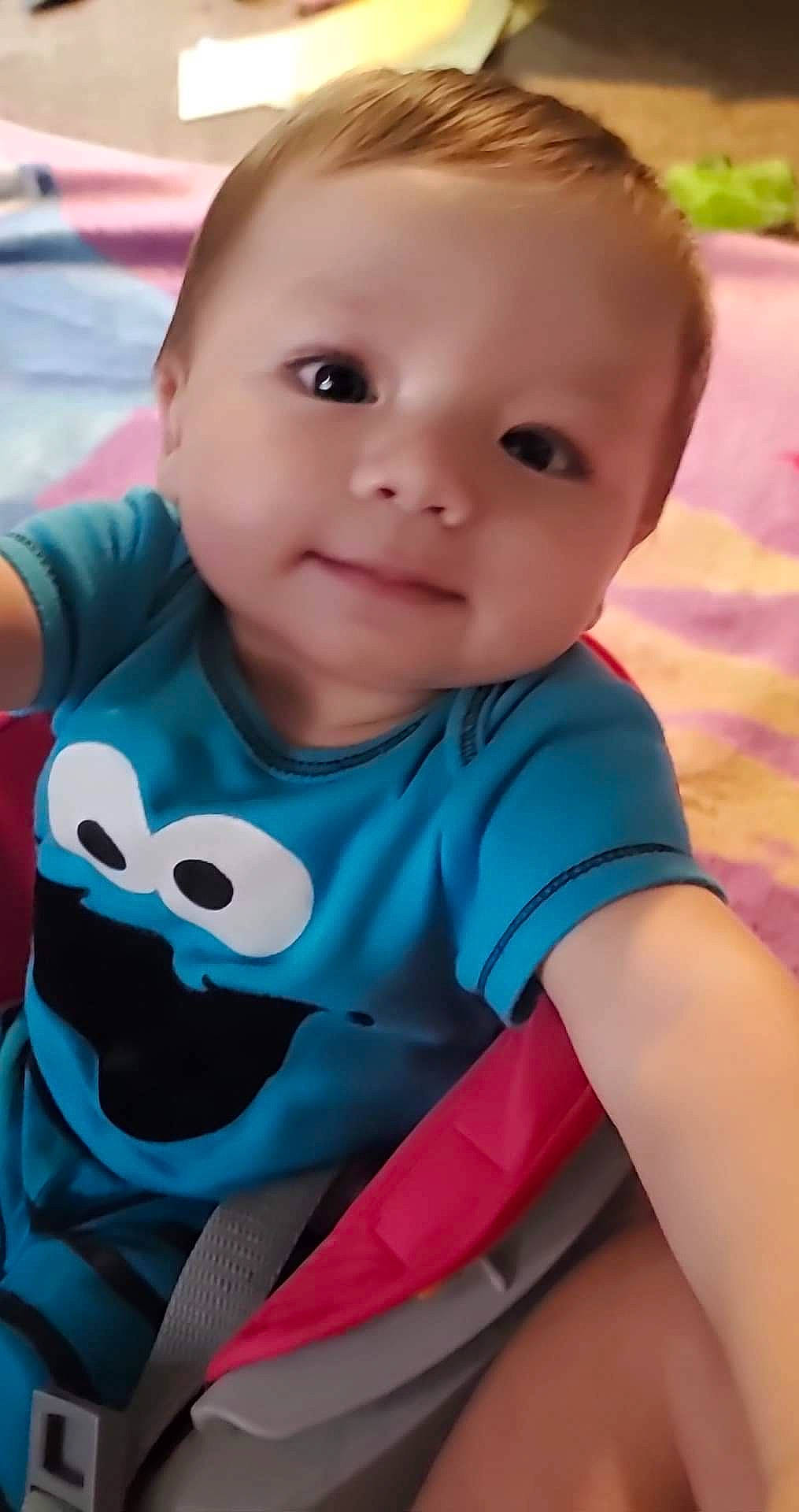 Loyal is registered to the contest to win money with this photo: arm, azure, baby, baby_toddler_clothing, cheek, child, cool, electric_blue, grass, happy, head, mouth, neck, nose, person, pink, skin, sleeve, smile, t_shirt