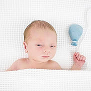 Greyson is registered to the contest to win money with this photo: baby, balloon, blanket, calm, child, cozy, cute, face, hand, indoors, infant, lying_down, newborn, portrait, skin, sleepy, soft_light, texture, toy, white