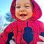 baby, baby_fashion, blue_sky, child, closeup, cute, daylight, face, hands, happy, hoodie, infant, jacket, nature, outdoor, person, portrait, red_clothing, smiling, spiderman