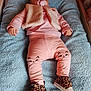 Manon participe au concours pour gagner de l'argent avec cette photo : baby, infant, pacifier, pink_clothing, cat_face_pants, leopard_print_shoes, blue_blanket, vest, lying_down, indoor, cute, child, person, footwear, soft_texture, sleepy, adorable, cozy, small_hands, baby_girl