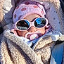 baby, infant, sunglasses, pacifier, hat, jacket, polka_dot, pink, beige, cozy, outdoor, reflection, sunlight, child, cute, warm_clothing, face, baby_accessory, winter_wear, portrait