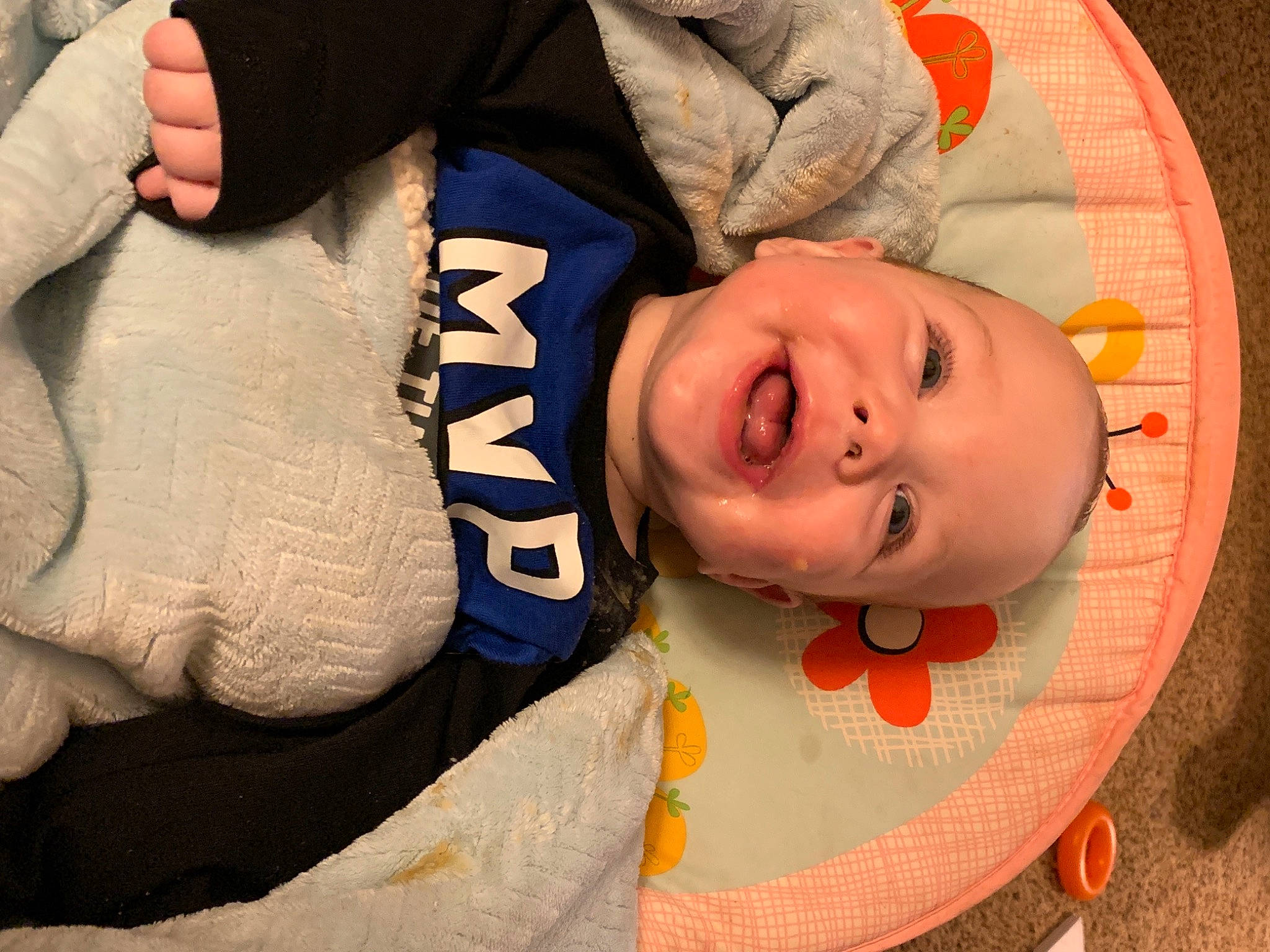 Marcellus is registered to the contest to win money with this photo: baby, cheek, child, comfort, elbow, finger, fun, gesture, hand, happy, head, headgear, mouth, person, skin, sleeve, smile, toddler, tree, wood