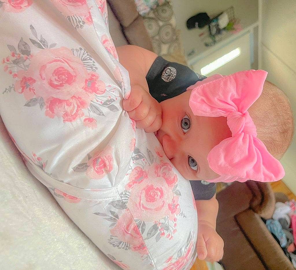 Brynleigh is registered to the contest to win money with this photo: baby_products, baby_toddler_clothing, carmine, child, creative_arts, embellishment, fashion_accessory, linens, magenta, nail, pattern, peach, person, pink, room, sleeve, stuffed_toy, textile, thumb, toy