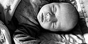 Arya participe au concours pour gagner de l'argent avec cette photo : baby, bed, blanket, child, closeup, clothing, comfort, cozy, cute, face, hand, indoors, infant, monochrome, newborn, peaceful, portrait, resting, sleeping, soft_texture