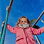 activity, blue_sky, casual, child, curly_hair, daylight, fun, holding, metal_frame, outdoor, person, pink_jacket, play, playground, portrait, rope, scarf, swing, winter_clothing, young_child