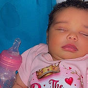 Jalaya is registered to the contest to win money with this photo: baby, sleeping, infant, pink_clothing, bottle, blanket, face, cute, child, resting, newborn, soft, peaceful, indoor, portrait, person, young_child, cozy, toddler, apparel