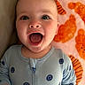 Carter joined the competition — help win amazing prizes! baby, smiling, onesie, blue_clothing, face, child, happy, infant, blanket, orange, pattern, mouth_open, cute, portrait, lying_down, skin, head, cheeks, eyes, expression