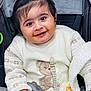 baby, blanket, child, clothing, cozy, cute, face, hand, happy, indoors, infant, person, pony_tail, portrait, smiling, stroller, sweater, teddy_bear, toddler, warm