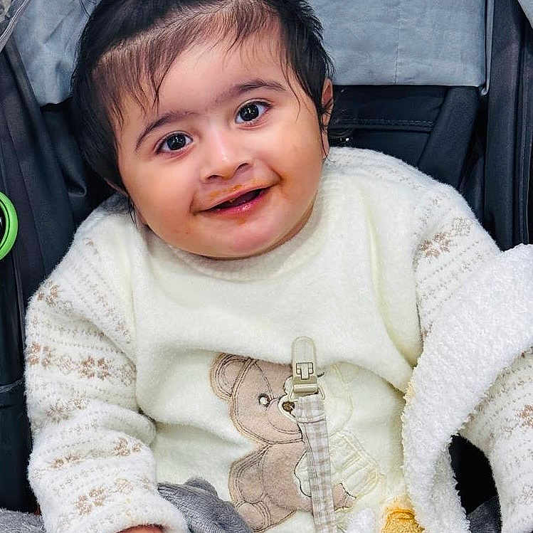 Darbjot joined the competition — help win amazing prizes! baby, blanket, child, clothing, cozy, cute, face, hand, happy, indoors, infant, person, pony_tail, portrait, smiling, stroller, sweater, teddy_bear, toddler, warm