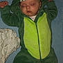 baby, sleeping, dinosaur_costume, green, hood, onesie, blanket, sock, infant, cute, child, soft, cozy, face, closed_eyes, lying_down, fabric, clothing, indoor, peaceful
