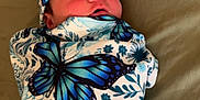 Rayann joined the competition — help win amazing prizes! newborn, baby, swaddled, butterfly_pattern, blanket, hat, infant, cute, resting, fabric, pattern, floral, blue, white, soft, bed, child, portrait, sleepwear, cozy