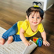 Guleen joined the competition — help win amazing prizes! toddler, child, yellow_shirt, blue_jeans, toy_keys, wooden_floor, white_rug, hair_tie, pony_tail, smiling, indoors, cute, playful, happy, baby, crawling, curious, bright_eyes, small_hands, floor
