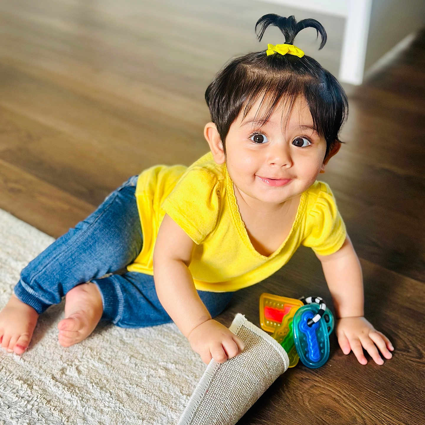 Guleen joined the competition — help win amazing prizes! baby, blue_jeans, bright_eyes, child, crawling, curious, cute, floor, hair_tie, happy, indoors, playful, pony_tail, small_hands, smiling, toddler, toy_keys, white_rug, wooden_floor, yellow_shirt