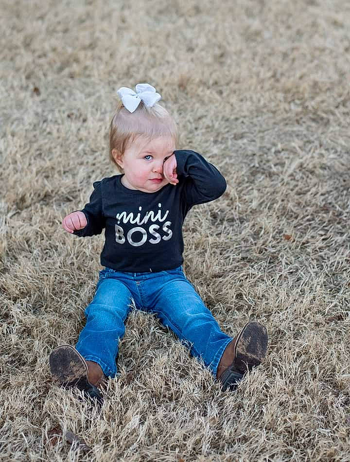Tennessee is registered to the contest to win money with this photo: baby, baby_toddler_clothing, boot, child, child_model, costume_accessory, hair_accessory, hay, headband, headpiece, human, human_body, mammal, overall, people_in_nature, person, photo_shoot, play, shoe, straw