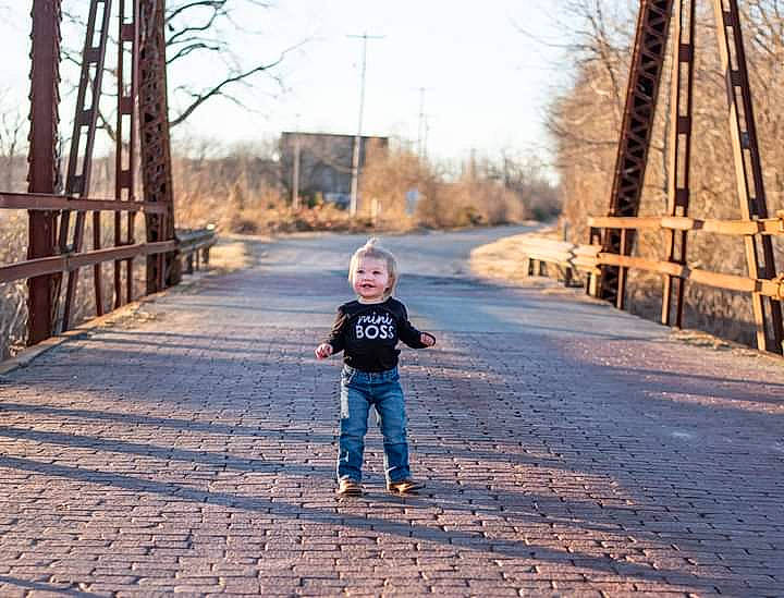 Tennessee is registered to the contest to win money with this photo: bridge, cobblestone, denim, iron, jeans, joy, ladder, nonbuilding_structure, person, shadow, street_fashion, toddler