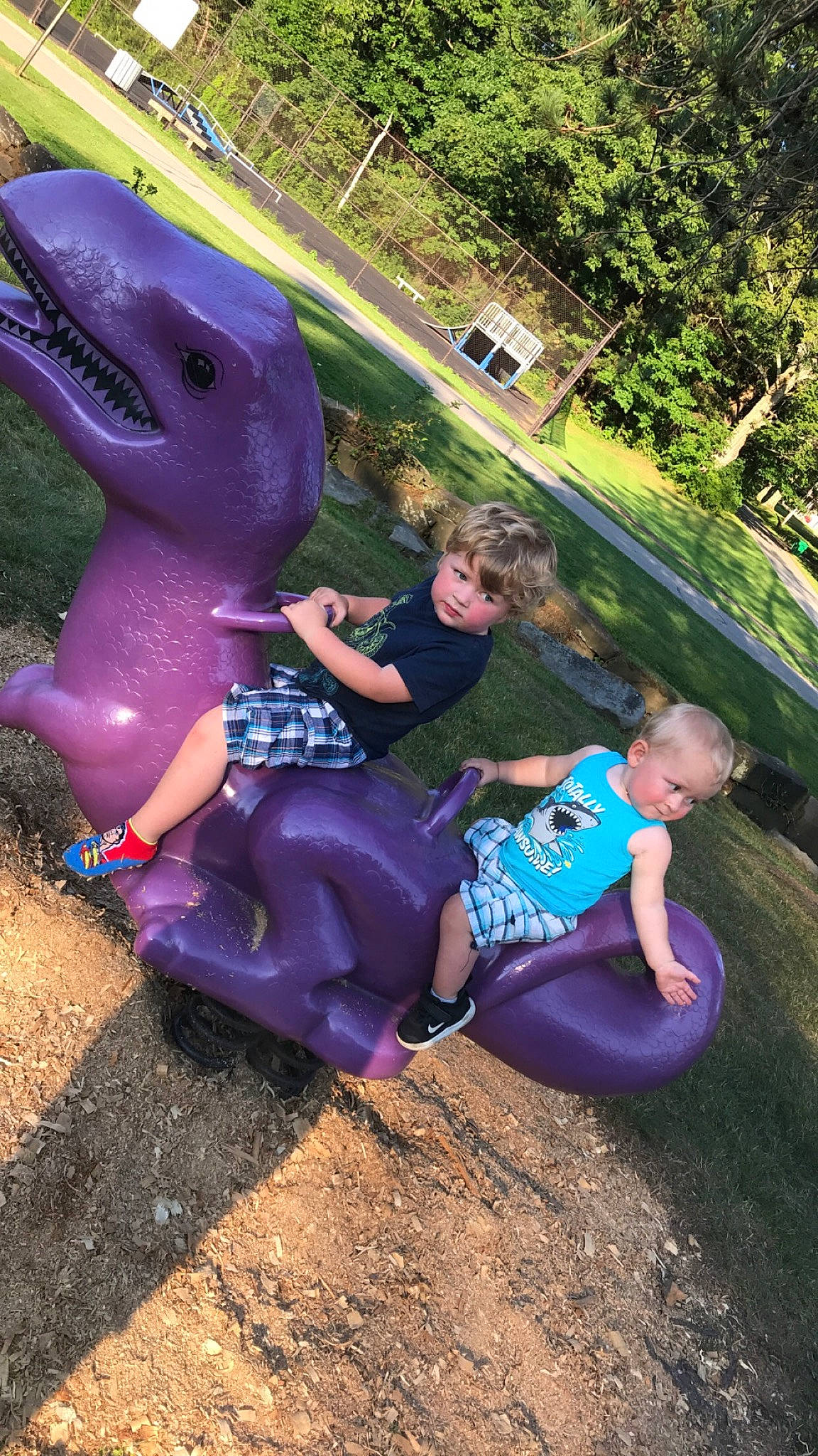 Karsen joined the competition — help win amazing prizes! blue, dinosaur, electric_blue, fun, grass, happy, head, landscape, leisure, magenta, mammal, person, pink, plant, public_space, recreation, shorts, t_shirt, tree, velociraptor