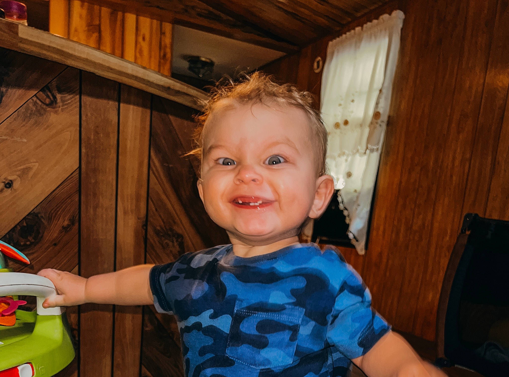 Kamden is registered to the contest to win money with this photo: cabinetry, chair, cheek, child, cupboard, door, drawer, fun, happy, hardwood, iris, joy, laugh, person, room, sitting, smile, t_shirt, toddler, varnish