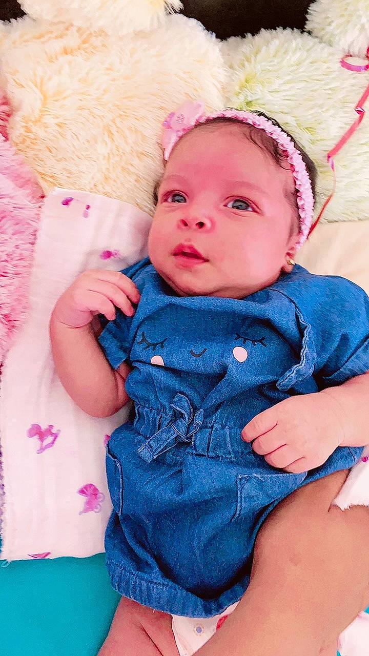 Gianna participe au concours pour gagner de l'argent avec cette photo : baby, baby_toddler_clothing, cheek, child, dress, eye, face, grass, happy, head, iris, lip, outerwear, pattern, person, pink, purple, skin, sleeve, textile