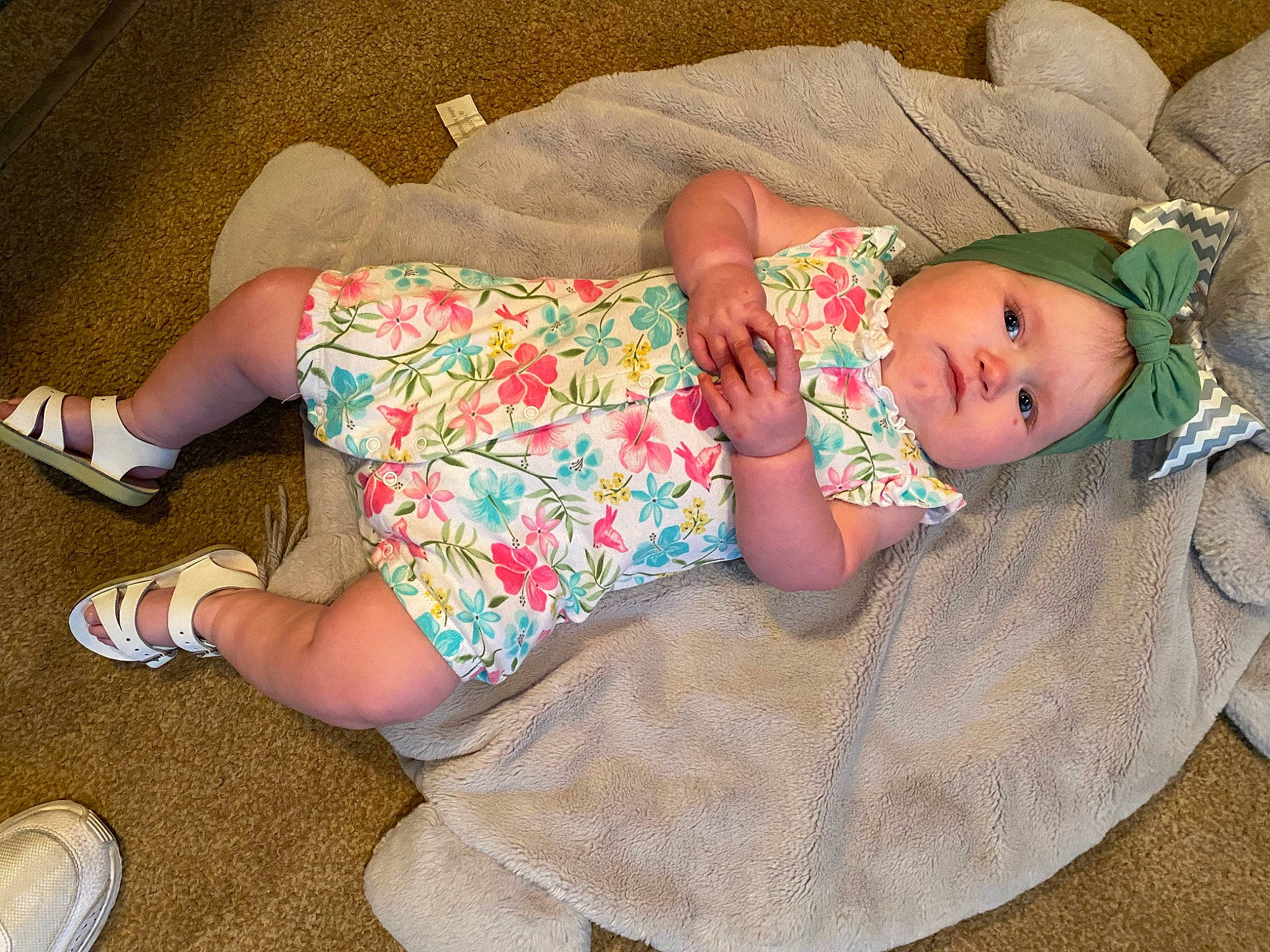 Amena is registered to the contest to win money with this photo: arm, baby, baby_products, baby_toddler_clothing, clothing, comfort, foot, hat, headgear, headwear, human_leg, knee, lap, pattern, person, pink, sitting, skin, sleeve, sock