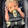 adorable, baby, button, car_seat, child, clothing, cute, expression, fabric, headband, indoor, infant, looking, pacifier, portrait, safety, seat, seatbelt, small_hands, straps